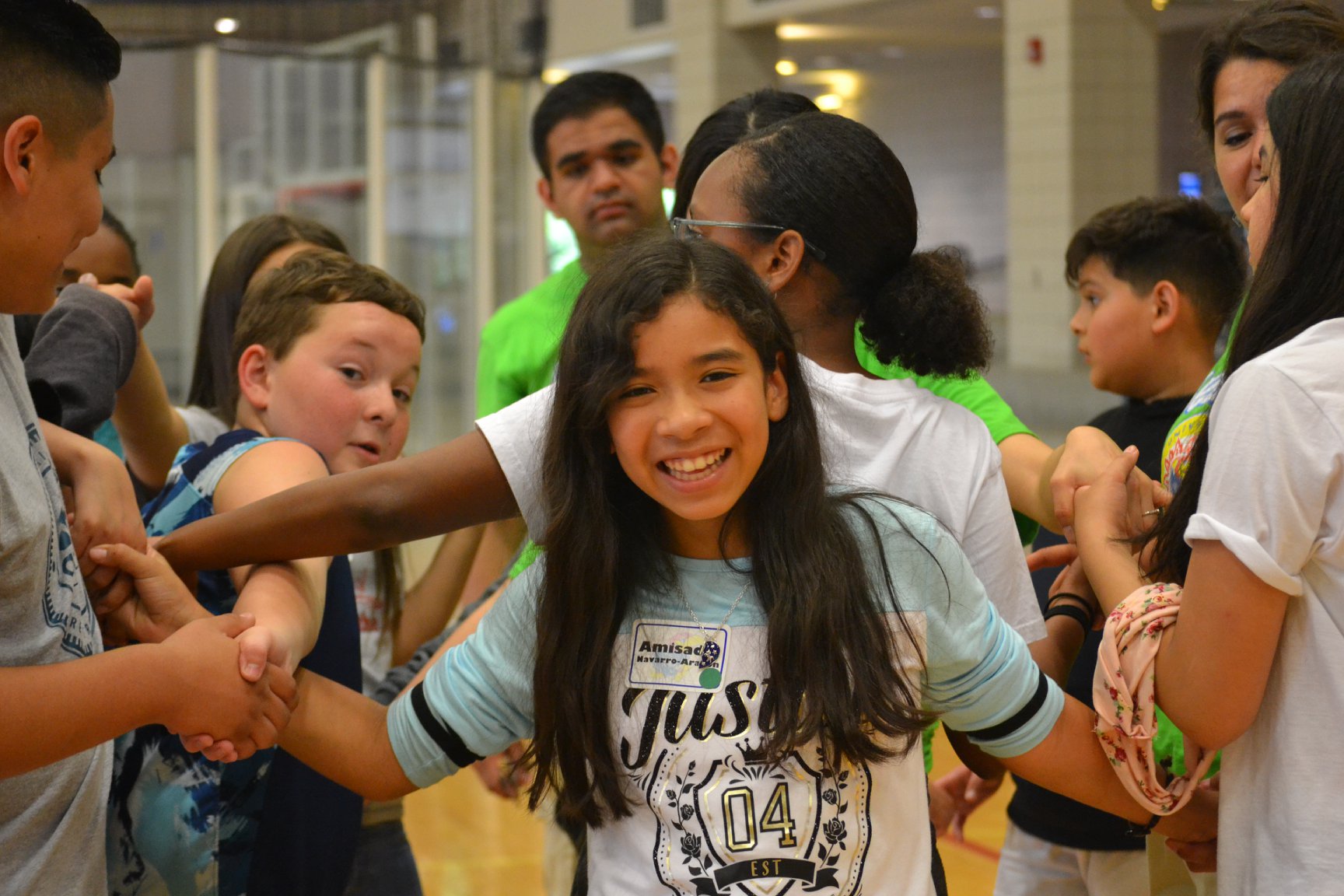 A student smiling while playing human knot