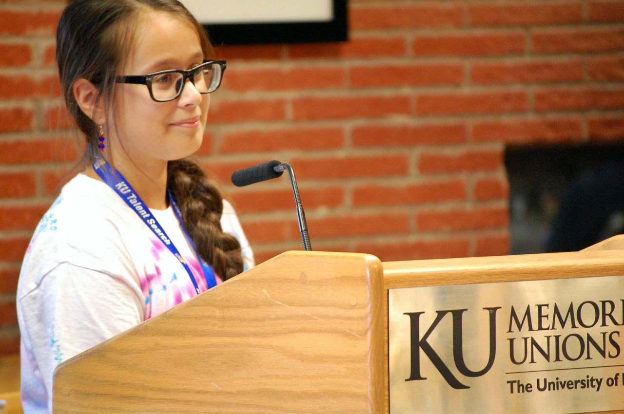 A student standing at a podium talking